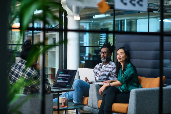 Three graphic designers discussing design strategy in meeting