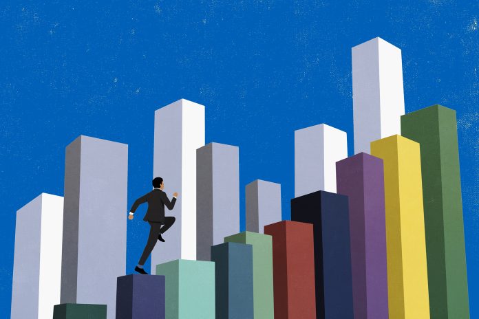 Businessman running up ascending multicolored bar graph